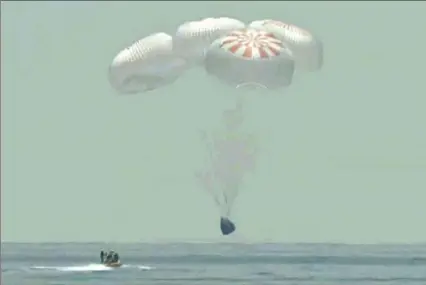  ?? NASA TV via Associated Press ?? In this frame grab from NASA TV, the SpaceX capsule splashes down Sunday in the Gulf of Mexico. Astronauts Doug Hurley and Bob Behnken spent a little over two months on the Internatio­nal Space Station. It marks the first splashdown in 45 years for NASA astronauts and the first time a private company has ferried people from orbit.