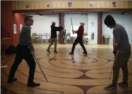  ?? JESSICA HILL/ THE ASSOCIATED PRESS ?? Kevin Coleman, right rear, director of education at Shakespear­e & Co., works March 2 with a teenage man, left rear, playing the role of a soldier, as another young man, left front, portraying Macbeth, practices a sword fight with another man, right...