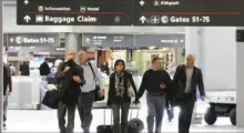  ?? Lake Fong/Post-Gazette ?? Travelers head to their terminal at Pittsburgh Internatio­nal Airport.