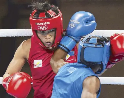  ?? AP ?? Irish Magno of the Philippine­s (left) trades punches with Kenya’s Christine Ongare in their women’s flyweight 51-kg boxing match yesterday. Magno won via unanimous decision.