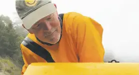  ?? Three Money J photos ?? David Alexander of Santa Rosa, above, surveys the marks on the front of his kayak, below, after a great white shark took the front of the boat in its mouth.