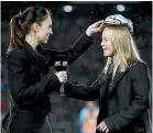  ??  ?? Kendra Cocksedge receives her 50th test cap from New Zealand Prime Minister Jacinda Ardern.