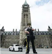  ?? SEAN KILPATRICK / THE CANADIAN PRESS ?? An RCMP officer stands watch on Parliament Hill after an incident during the Changing the Guard parade.