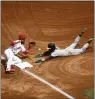  ?? RONALD MARTINEZ — GETTY IMAGES ?? Esteury Ruiz of the A's steals his American League rookiereco­rd 67th base during the third inning of Sunday's game against the Angels.