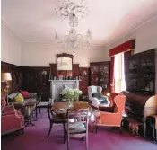  ??  ?? The drawing room features mahogany-panelled walls
