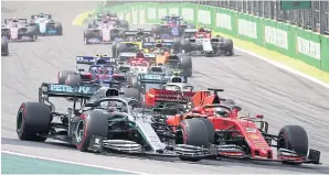  ??  ?? Mercedes’ Lewis Hamilton, left, and Ferrari’s Sebastian Vettel in action at the 2019 Brazilian Grand Prix.