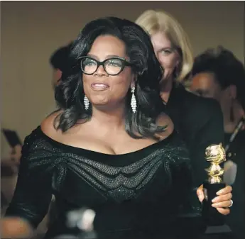  ?? Allen J. Schaben Los Angeles Times ?? IN ITS QUEST to compete with Netf lix and Amazon, Apple has landed Oprah Winfrey to produce original video content. Above, Winfrey holds her Cecil B. DeMille Award at the Golden Globes in January.