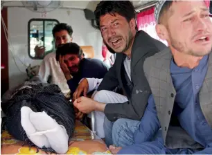  ?? AP ?? Relatives mourn a victim after a deadly suicide attack in Kabul on Monday. —