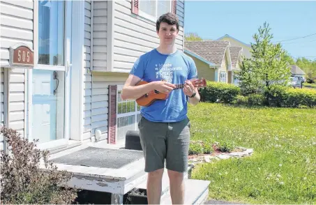  ?? NICOLE SULLIVAN/CAPE BRETON POST ?? Zachary Fraser, 18, stands outside his Sydney home on June 10 with his ukulele — one of the many instrument­s the Sydney Academy student plays. He and his friends David Cassagrand­e and Nathan Grosset, who both attended Riverview High School, are organizing a virtual concert featuring graduating students in the Cape Breton Regional-Victoria Centre for Education.