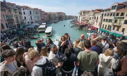  ?? Photograph: Bloomberg/Getty Images ?? Tourists on the Rialto Bridge. The UN cultural agency said in July that Venice faced ‘irreversib­le’ damage due to factors ranging from tourism to climate breakdown.