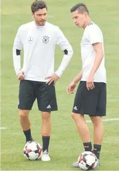  ??  ?? Germany’s Jonas Hector (left) and Julian Draxler speak ahead a training session in Herzogenau­rach, southern Germany on the eve of the FIFA World Cup 2018 qualifying match between Germany and San Marino in this June 9 file photo. — AFP photo