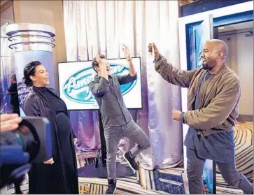  ?? Photograph­s by Michael Becker Fox ?? KANYE WEST shows off his golden ticket to Ryan Seacrest and Kim Kardashian at surprise “Idol” audition.