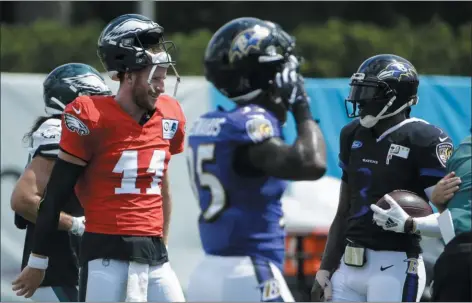  ?? MATT ROURKE — THE ASSOCIATED PRESS ?? Eagles quarterbac­k Carson Wentz, left, talks to Baltimore Ravens quarterbac­k Robert Griffin III during a joint practice Tuesday. Might the Birds’ QB get any closer to game action in Thursday night’s preseason tilt?