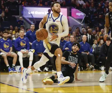  ?? NHAT V. MEYER — BAY AREA NEWS GROUP FILE ?? Golden State Warriors' Stephen Curry (30) heads to the basket against Brooklyn Nets' Seth Curry (30) in the second quarter at the Chase Center in San Francisco on Jan. 22.