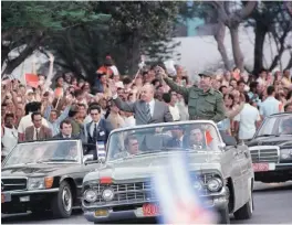  ??  ?? This file photo taken on April 02, 1989 shows then General Secretary of the Communist Party of the Soviet Union Mikhail Gorbachev (standing left) and Castro (standing right) greeting onlookers en route from the airport upon Gorbachev’s arrival in Havana.