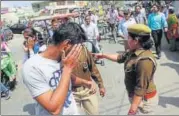  ?? HT PHOTO ?? Police question men outside RG PG College for Women in Meerut.