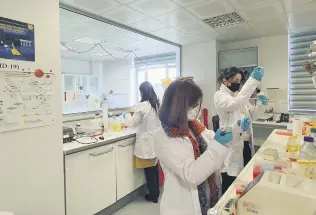  ??  ?? Scientists work at the laboratory at Boğaziçi University, in Istanbul, Turkey, Feb. 25, 2021.