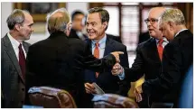  ?? TAMIR KALIFA / AMERICAN-STATESMAN ?? House Speaker Joe Straus (center), R-San Antonio, speaks Tuesday with fellow state representa­tives in the House chamber as the special session gets underway.