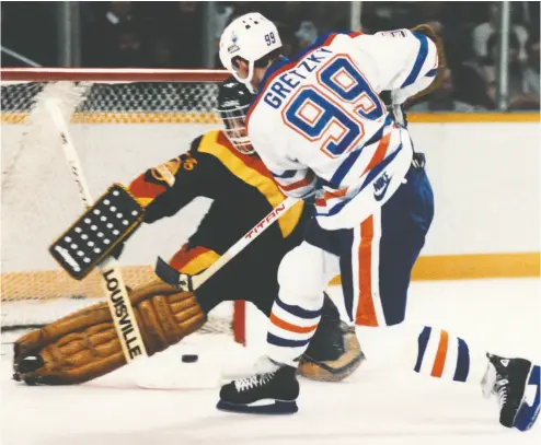  ?? POSTMEDIA NEWS FILES ?? Wayne Gretzky fires the puck through the legs of a Canucks goalie during a game in January 1984, the first year the
Oilers won the Stanley Cup. “Skate to where the puck is going, not where it has been,” the Great One has said.