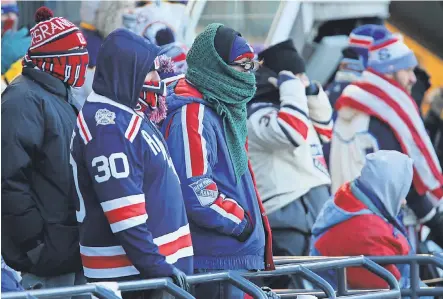  ??  ?? Fans brave Monday’s Winter Classic outdoor hockey game between the New York Rangers and the Buffalo Sabres at Citi Field in Queens, N.Y. Despite the freeze, New Year’s Day festivitie­s in many cities went on. DANNY WILD/USA TODAY SPORTS