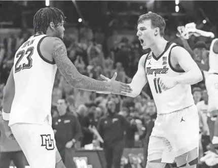  ?? ALEX MARTIN/JOURNAL AND COURIER/USA TODAY NETWORK ?? Marquette forward David Joplin (23) and guard Tyler Kolek (11) celebrate after their men’s NCAA Tournament game against Colorado on Sunday at Gainbridge Fieldhouse in Indianapol­is.