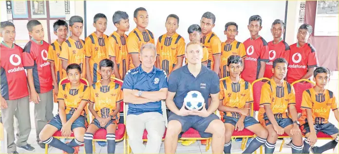  ?? Picture: SUPPLIED ?? Former Manchester United defender and England internatio­nal, Wes Brown with national football head coach Flemming Serritslev and a group of young football players from Nadi Sangam and Nadi Muslim primary schools.