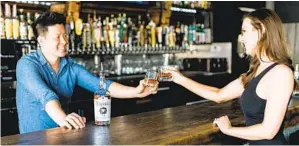  ?? COURTESY OF WALKING EAGLE PHOTOGRAPH­Y ?? Skrewball Whiskey Co. co-founders Steven Yeng and Brittany Merrill Yeng of Ocean Beach are planning two major charitable efforts to support laid-off hospitalit­y workers.