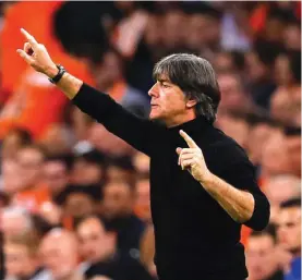  ??  ?? Joachim Loew instructs his players during the 0-3 defeat against The Netherland­s Photo: AP