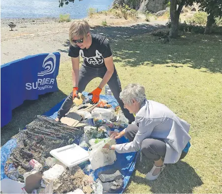  ?? JEFF BELL, TIMES COLONIST ?? Gillian Montgomery, chapter manager for the Surfrider Foundation on Vancouver Island, and Victoria Mayor Lisa Helps sort through some of the plastic refuse gathered from the Inner Harbour shoreline.