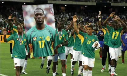  ?? Photograph: Philippe Wojazer/Reuters ?? Cameroon team players carry a giant portrait of their late team mate Marc-Vivien Foe. Foe died after collapsing on the pitch during theirmatch against Colombia.