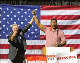  ?? John Bazemore Associated Press ?? HERSCHEL WALKER, right, shown with Sen. Lindsey Graham (R-S.C), was inextricab­ly linked to former President Trump by his political opponent.