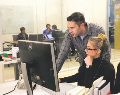  ?? Photos by Lea Suzuki / The Chronicle ?? Above: Visual design manager Jordan Black (left) and product marketing manager Alyx Gatti work at Charboost, which helps companies place ads to reach mobile game players.