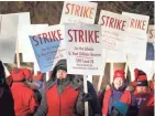  ?? GLEN STUBBE/STAR TRIBUNE VIA AP ?? St. Paul teachers picket outside Adams Elementary in St. Paul on Tuesday. The teachers union and the district reached a tentative contract agreement early Friday, in part because of the uncertaint­y about the coronaviru­s impact.