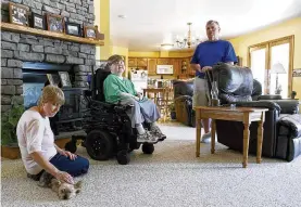  ?? AP ?? Terry Horgan, shown with his parents in the family’s Montour Falls, N.Y., home. Horgan, a 27-year-old who had Duchenne muscular dystrophy, died last month, according to Cure Rare Disease, a nonprofit founded by his brother, Rich, to try and save him.