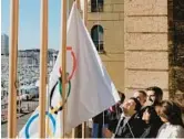  ?? THIBAULT CAMUS/AP ?? Mayor of Marseille Benoit Payan, center, raises the Olympic flag with Paris 2024 president Tony Estanguet, center right, Friday in southern France.