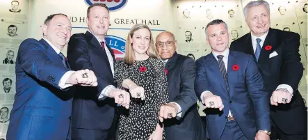  ?? NATHAN DENETTE/THE CANADIAN PRESS ?? The newest members of the Hockey Hall of Fame — from left, Gary Bettman, Martin Brodeur, Jayna Hefford, Willie O’Ree, Martin St. Louis and Alexander Yakushev — show off their rings following the induction ceremony Monday in Toronto.