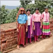  ??  ?? Somibai and daughters with bricks they have made.