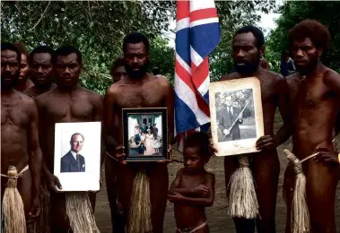  ??  ?? ABOVE:
The men of Yakel village hold portraits of Prince Philip after hearing of his death.