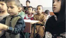  ?? PHOTO: REUTERS ?? Lean times . . . Children attend lessons at their orphanage in Kabul, Afghanista­n, recently.