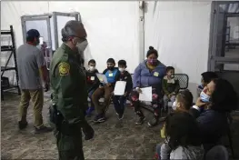  ?? PHOTOS BY DARIO LOPEZ-MILLS — THE ASSOCIATED PRESS ?? Migrants are processed at the intake area of the U.S. Customs and Border Protection facility in the Rio Grande Valley in Donna, Texas.