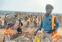  ??  ?? Rohingya labourers clear hilltops to serve as campsites that authoritie­s hope will be able to endure flooding, near the Kutupalong camp in April.