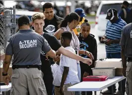  ?? ALLEN EYESTONE PHOTOS / THE PALM BEACH POST ?? Everyone entering the stadium is checked with a metal detector at Palm Beach Central high school in Wellington on Friday.