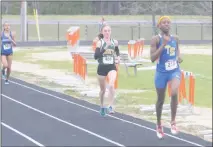  ?? STAFF PHOTO BY TED BLACK ?? Thomas Stone High School senior Mone’t Peterson leads field past the halfway point of the girls 1,600-meter run on Thursday afternoon at Westlake High School. Peterson captured the event by nearly 10 seconds and was the bright spot for the Cougars who...