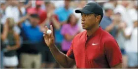  ?? THE ASSOCIATED PRESS ?? Tiger Woods waves to the crowd after sinking a birdie putt on the 15th green during Sunday’s final round of the PGA Championsh­ip at Bellerive Country Club.