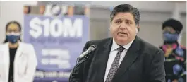  ?? ANTHONY VAZQUEZ/SUN-TIMES ?? Gov J.B. Pritzker discusses the state vaccine lottery Thursday in front of a sign showing prizes totaling $10 million, at Access Community Health Network in Back of the Yards.