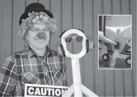  ?? [ALI WILSON / THE OBSERVER] ?? ‘Safety Sam’ demonstrat­ing proper eye and ear safety on his model friend ahead of the Farm Safety Talk and pancake breakfast this Saturday at the Alma Community Centre. Insert: a model display of the dangers of playing in grain bins.