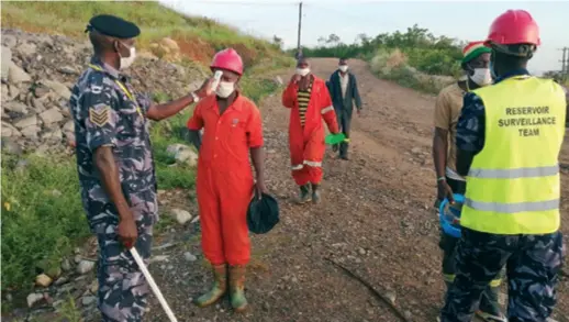  ??  ?? Employees of the Isimba Hydro Power Project have their temperatur­e taken before starting to work