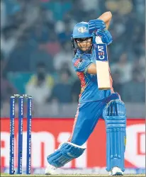  ?? SPORTZPICS/AFP ?? Mumbai Indians skipper Harmanpree­t Kaur hit 65 off 30 balls against Gujarat Giants on Saturday. (Right) Actor Kiara Advani takes part in the opening ceremony at the DY Patil stadium in Navi Mumbai.