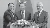  ??  ?? (From left) Afghanista­n foreign minister Salahuddin Rabbani, Chinese FM Wang Yi and Pakistani FM Khawaja Asif hold hands to pose for a photo after a press conference for the first China-Afghanista­nPakistan foreign ministers’ dialogue held in Beijing.