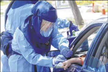  ?? Rick Bowmer The Associated Press ?? Salt Lake County nurse Lee Cherie Booth performs a coronaviru­s antibody test Thursday in Salt Lake City.